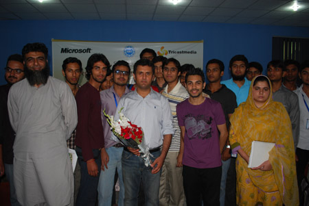 Students pose for a group photo with Ali Malik